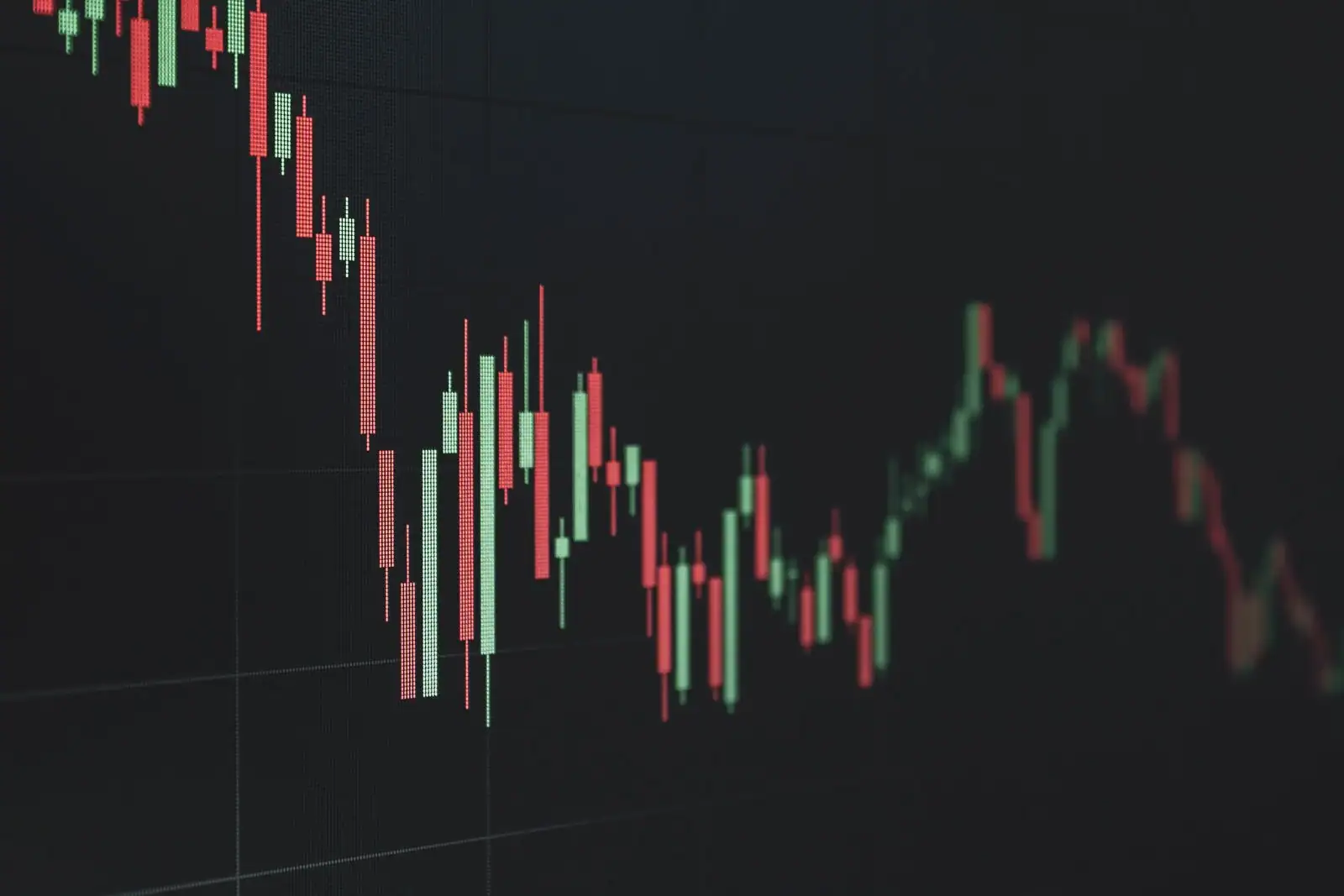 Graphique boursier en chandeliers rouges et verts illustrant l'évolution des cours de marché.