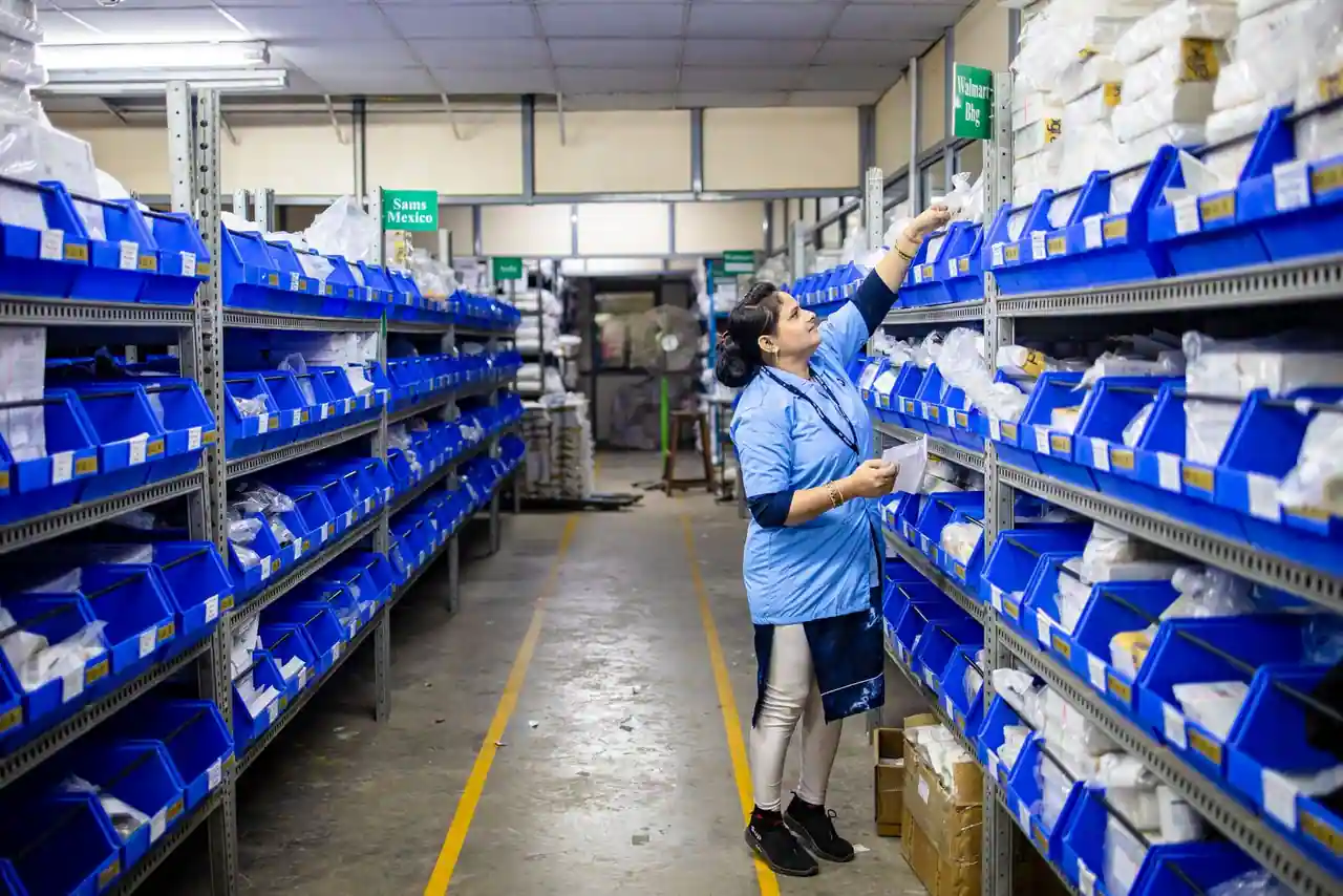 Employée de logistique préparant des commandes dans les rayonnages d'un entrepôt